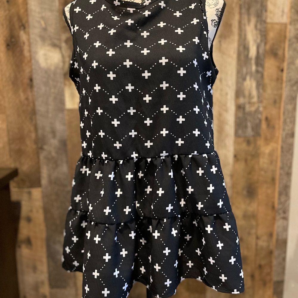 Black printed tank top with ruffled hem